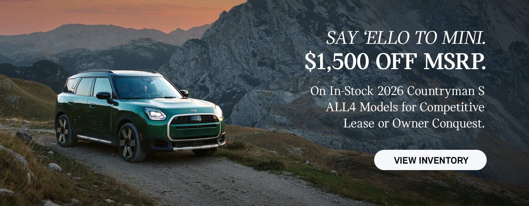 Front passenger side view of a MINI Countryman  driving on a mountainous road.