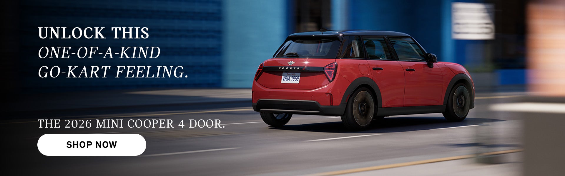 Red MINI Cooper 4-door driving on a city street, with motion blur in the background and ad text promoting the 2026 model