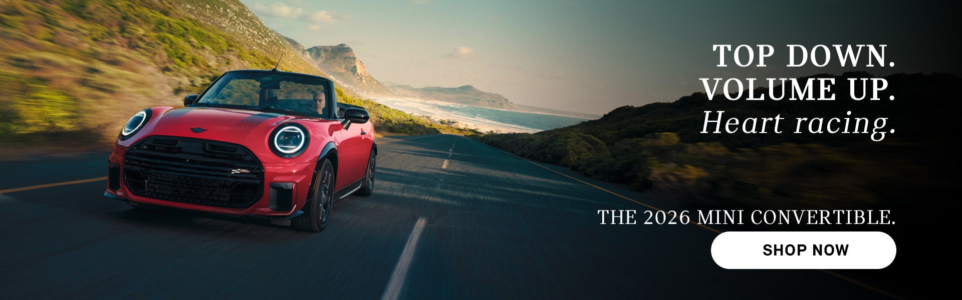 Red MINI convertible driving along a coastal road with mountains and ocean in the background, with advertisement text
