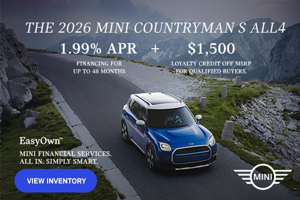 Front passenger side view of a MINI Countryman  driving on a mountainous road.