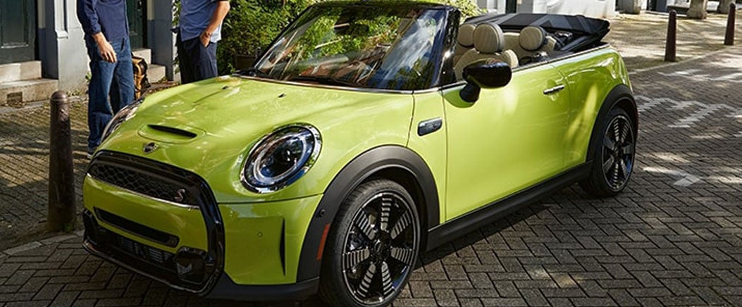 A side view of the MINI Convertible parked downtown.