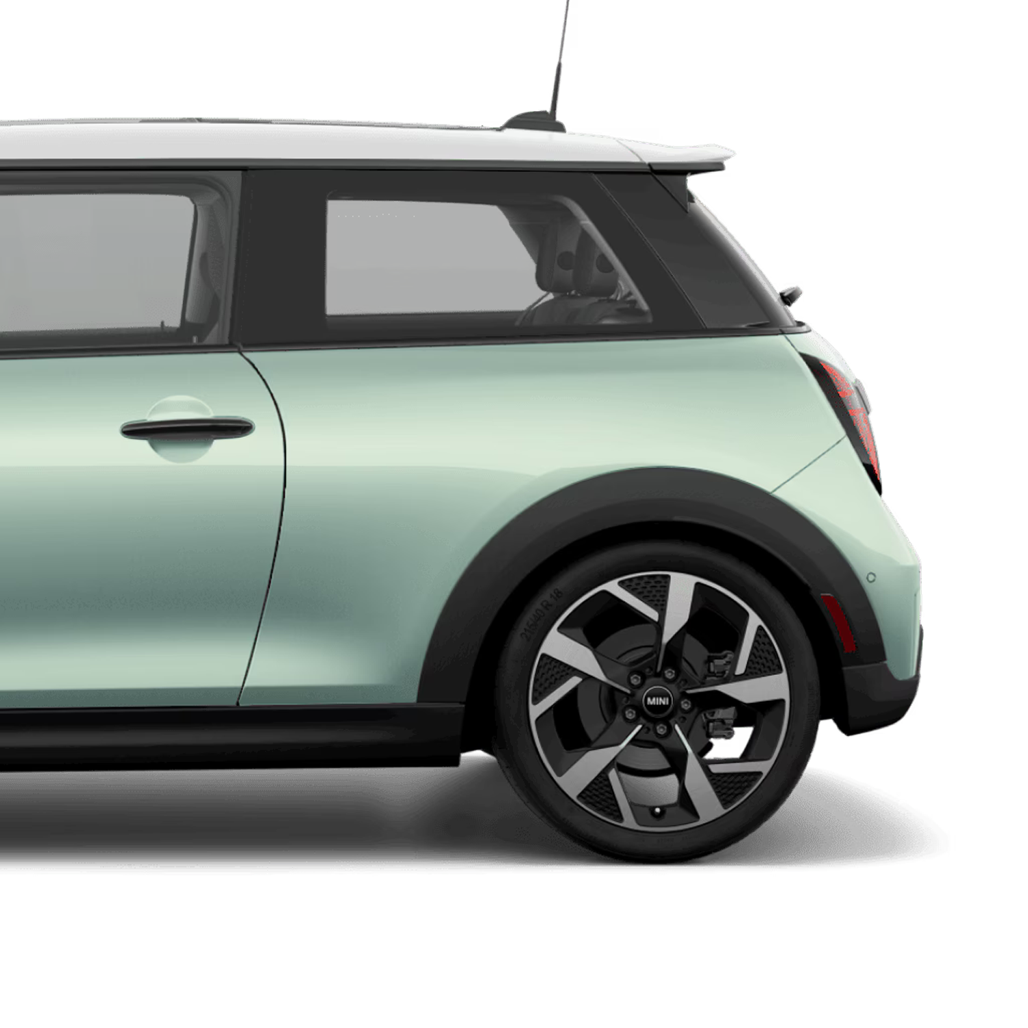 Side view of the rear of a MINI Cooper S 2 Door in Ocean Wave Green, parked on a blank white surface with its shadow underneath it and nothing in the background.