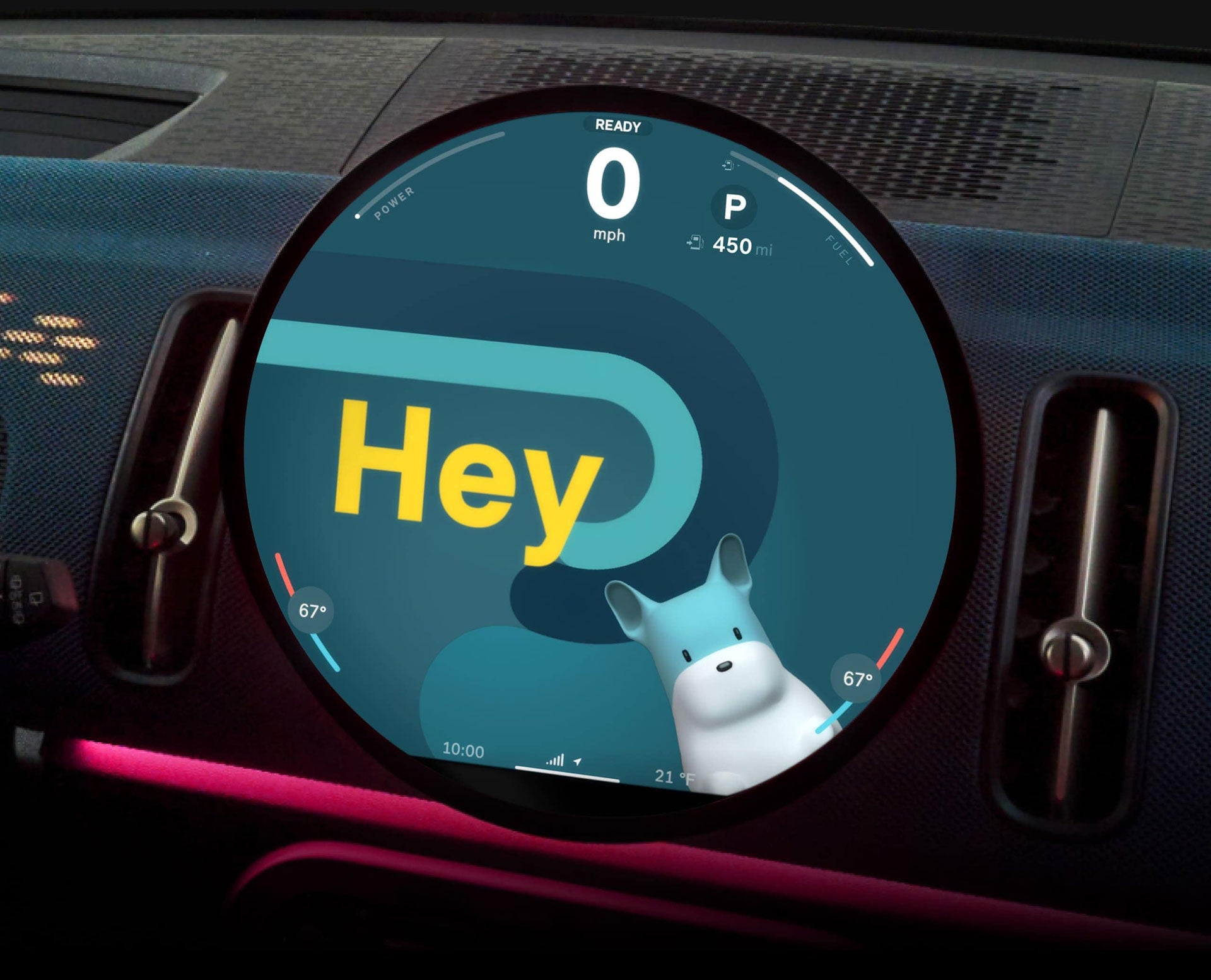 A close-up of the 9.4” round OLED display with Spike on the screen and text reading “Hey” with the surrounding dashboard against a black background.