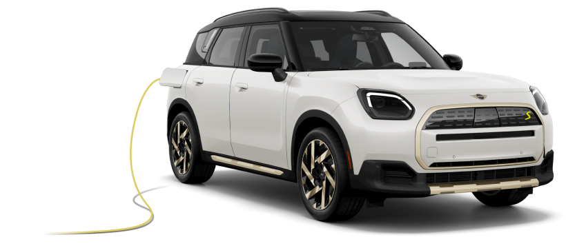 Angled view of a white MINI Cooper SE Electric Hardtop 2 Door and MINI Countryman SE ALL4 parked next to each other against a white brick background.